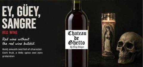 A dark promotional graphic for Chateau de Ghetto red wine. On the right, a bottle of red wine with a white label stands beside a lit candle in a glass holder and a skull, with the text 'EY, GÜEY, SANGRE' and red wine descriptors on the left.
